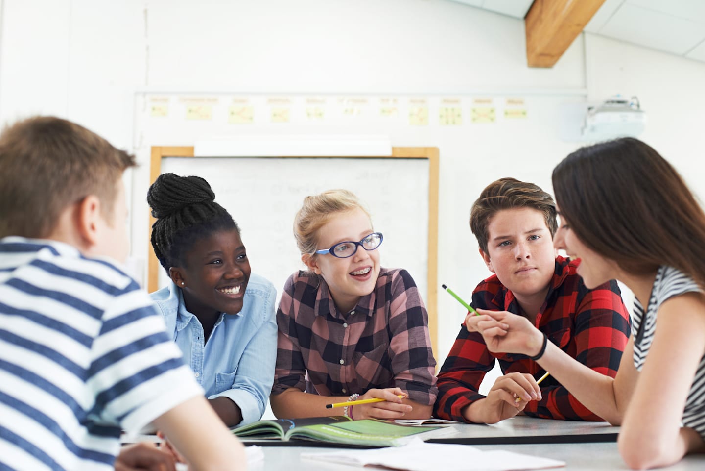 A group of students having a discussion around a table.