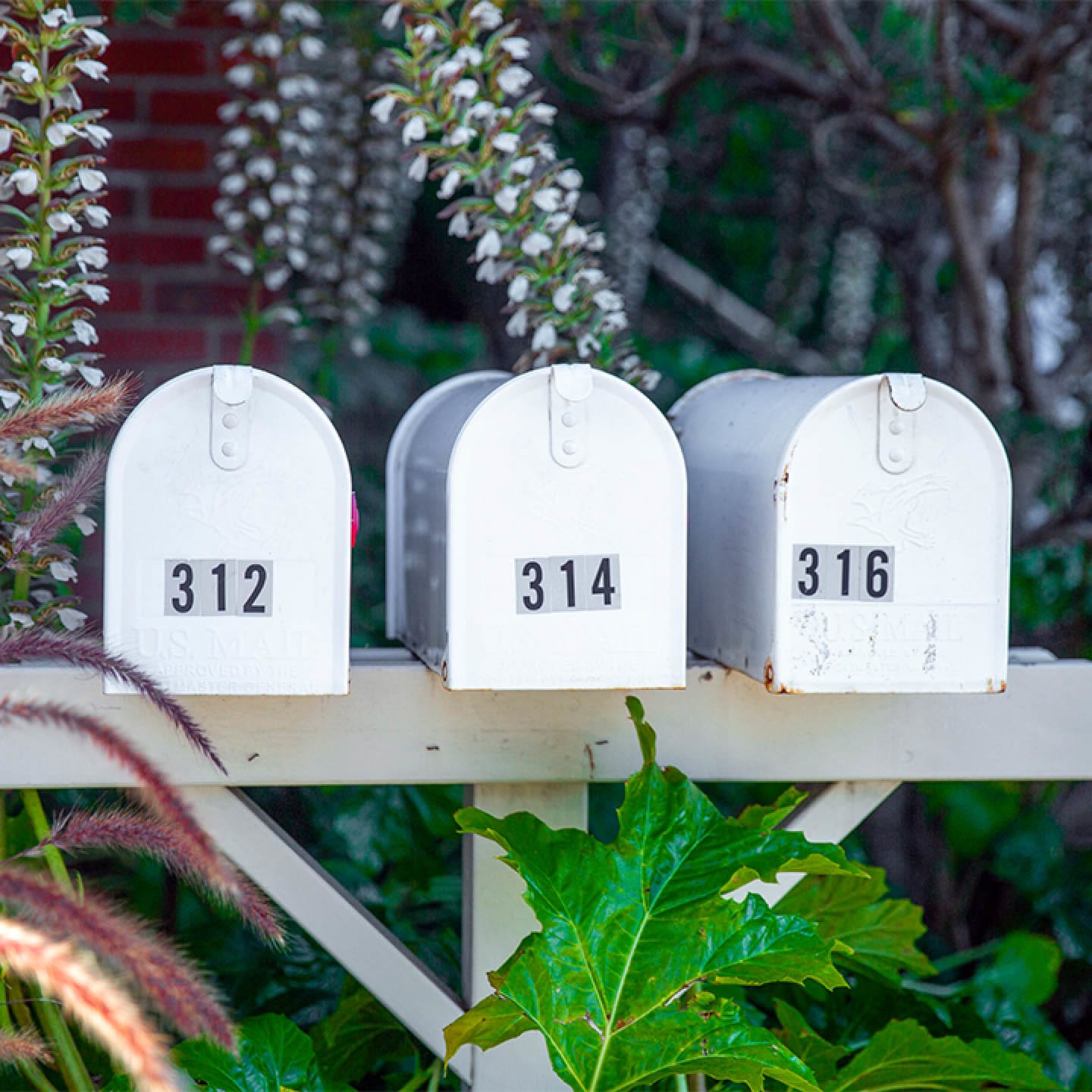 Three mailboxes in a row.