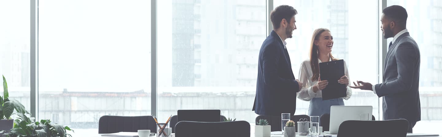 Co-workers having discussion in board room.