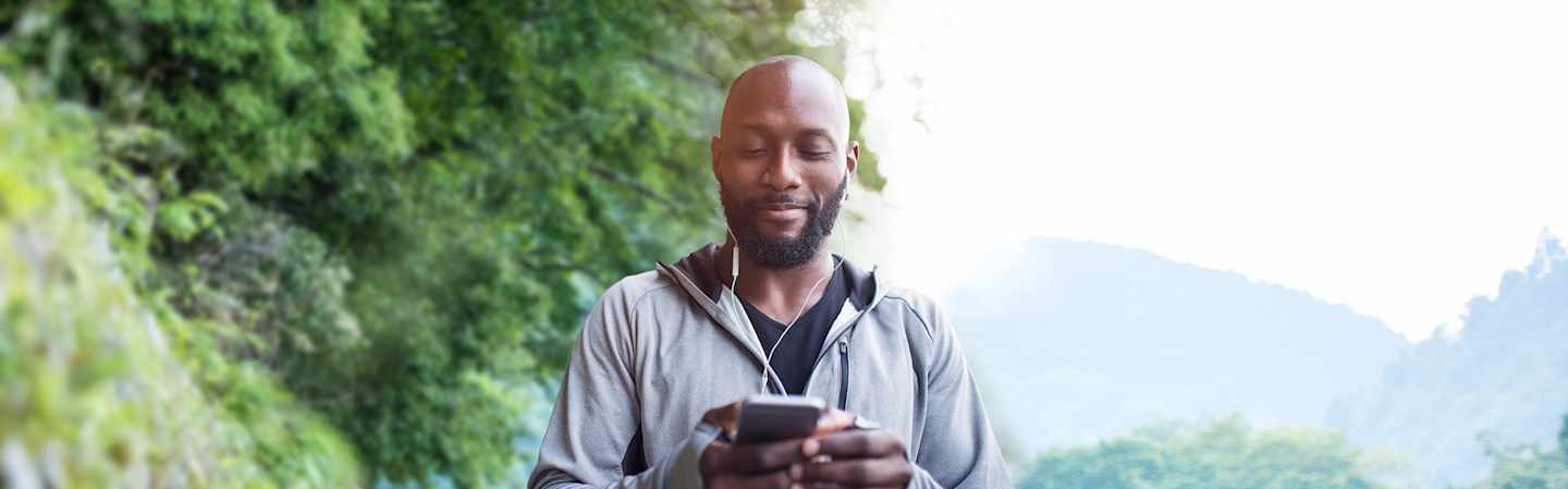 Man out on walk in nature with cell phone.