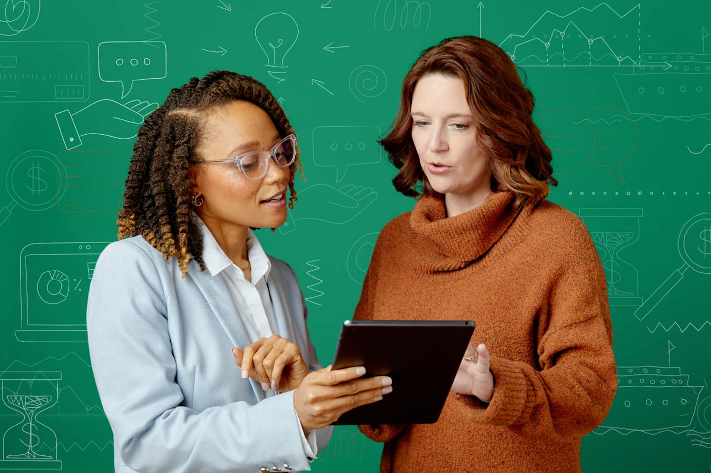 Two professionals having discussion with laptops.