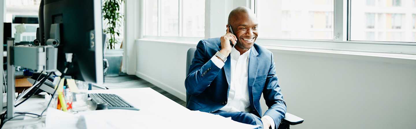 Working man on phone with client.