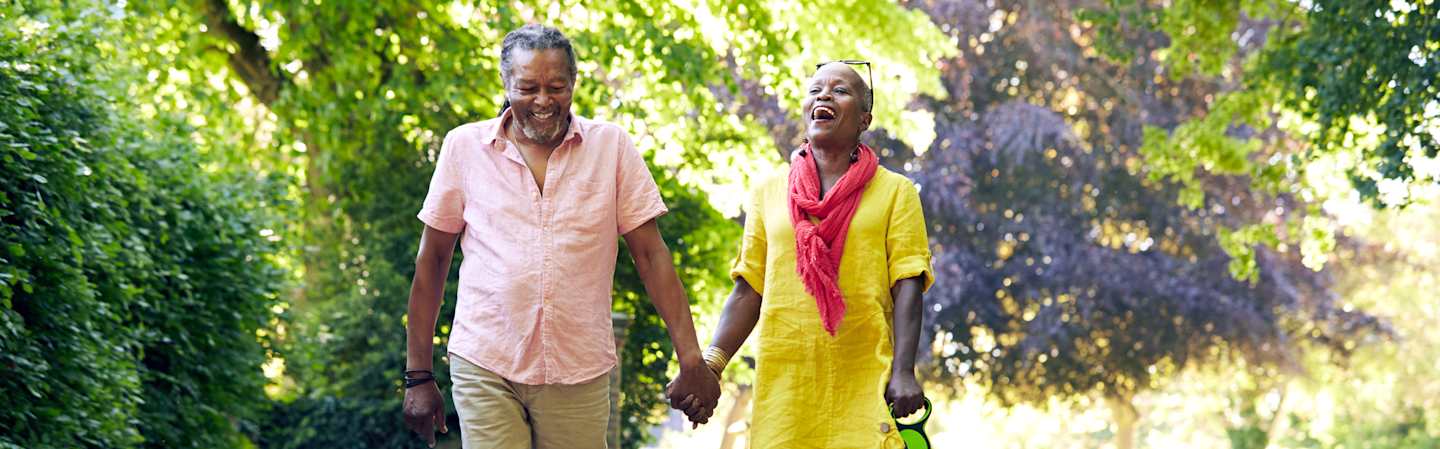 Retired couple taking a walk outdoors.