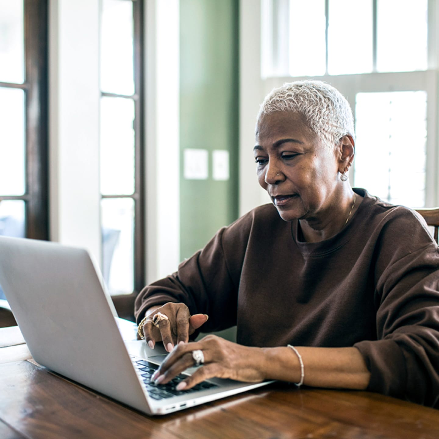 Retired woman working on laptop.