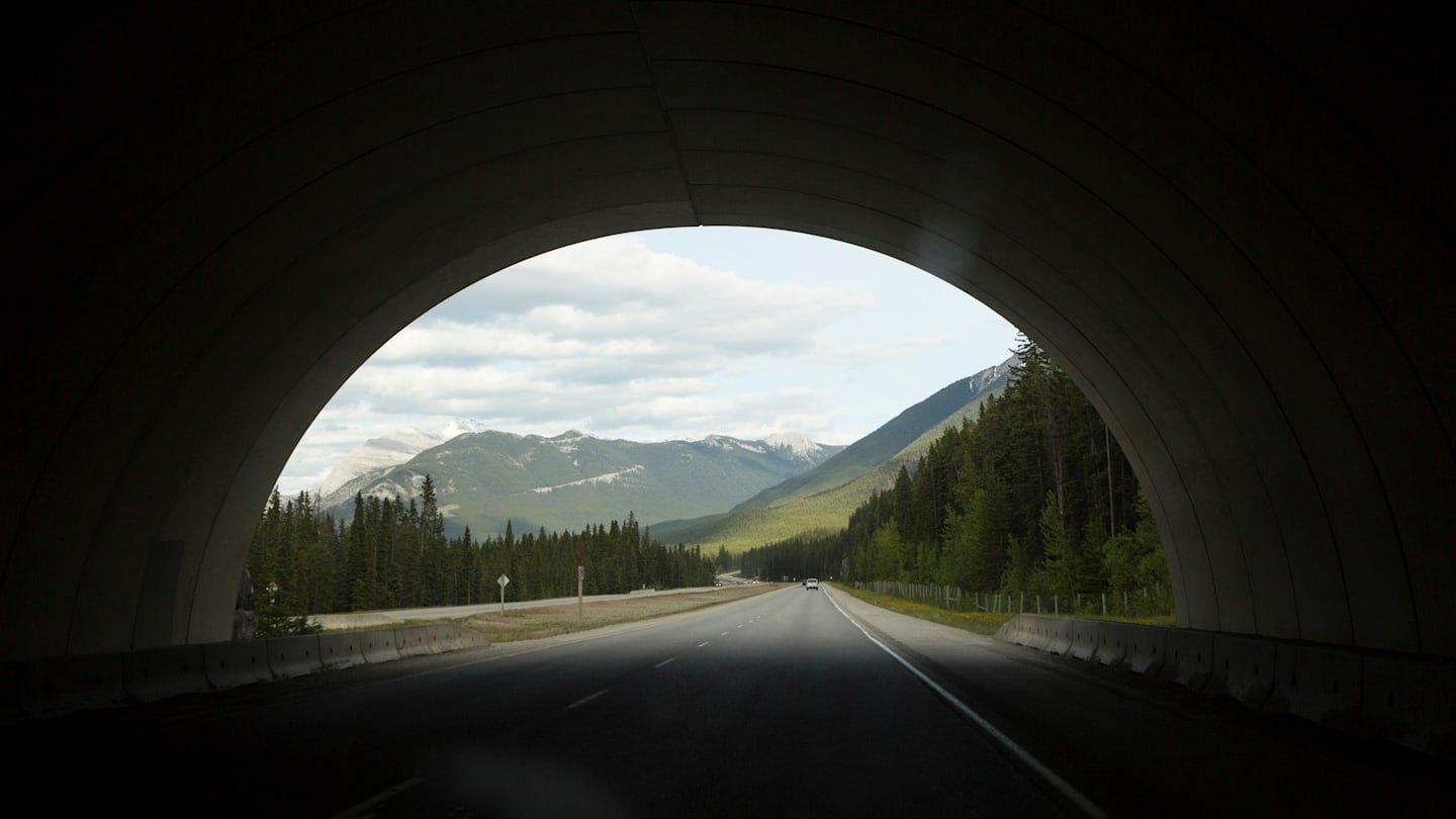 Image of the mountains from inside a highway tunnel.