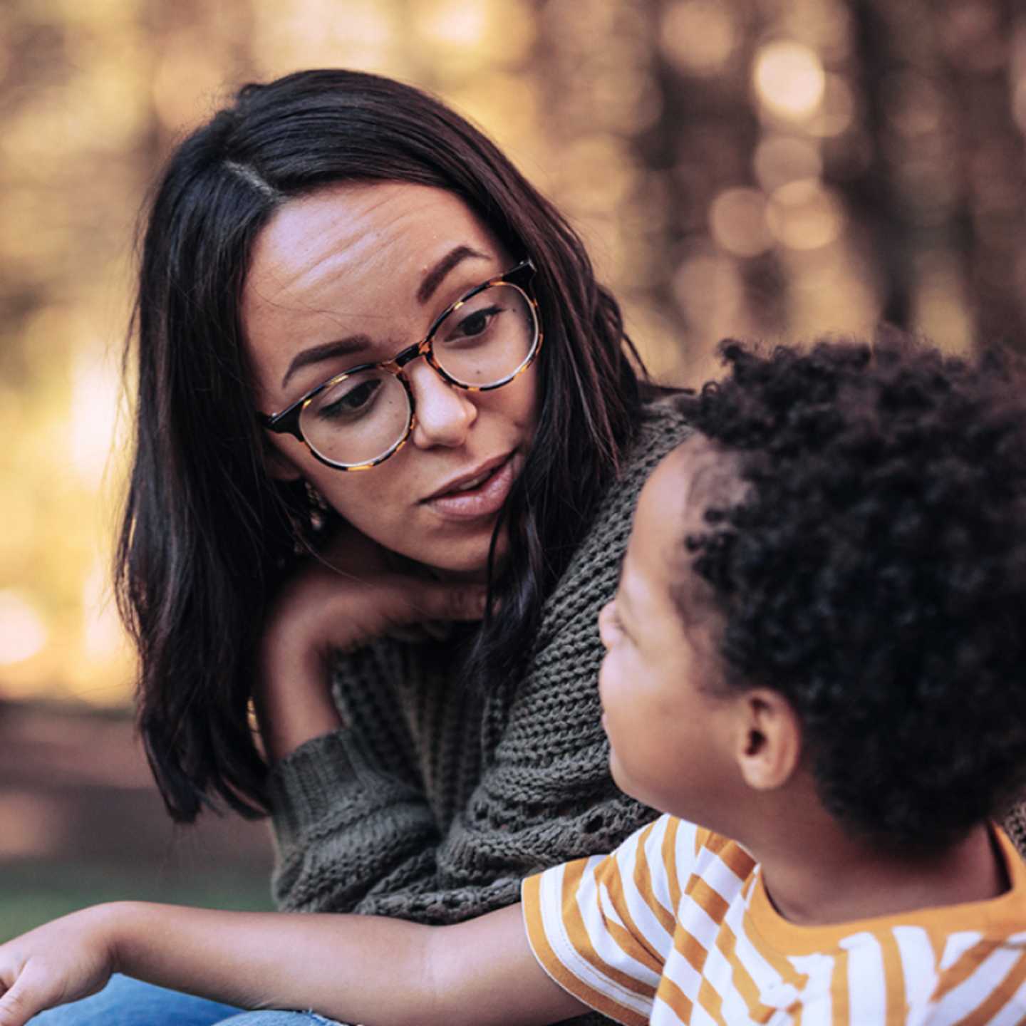 Parent talking to young child.