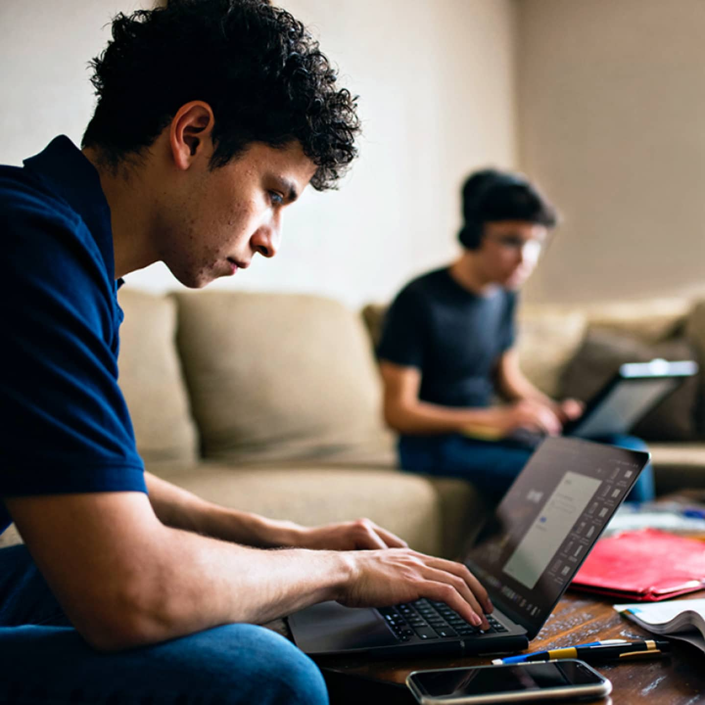 College-aged students working in apartment.