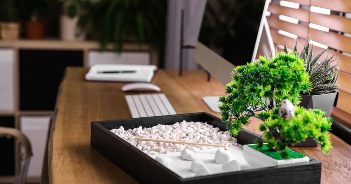 An image of a desk with a bonsai tree.