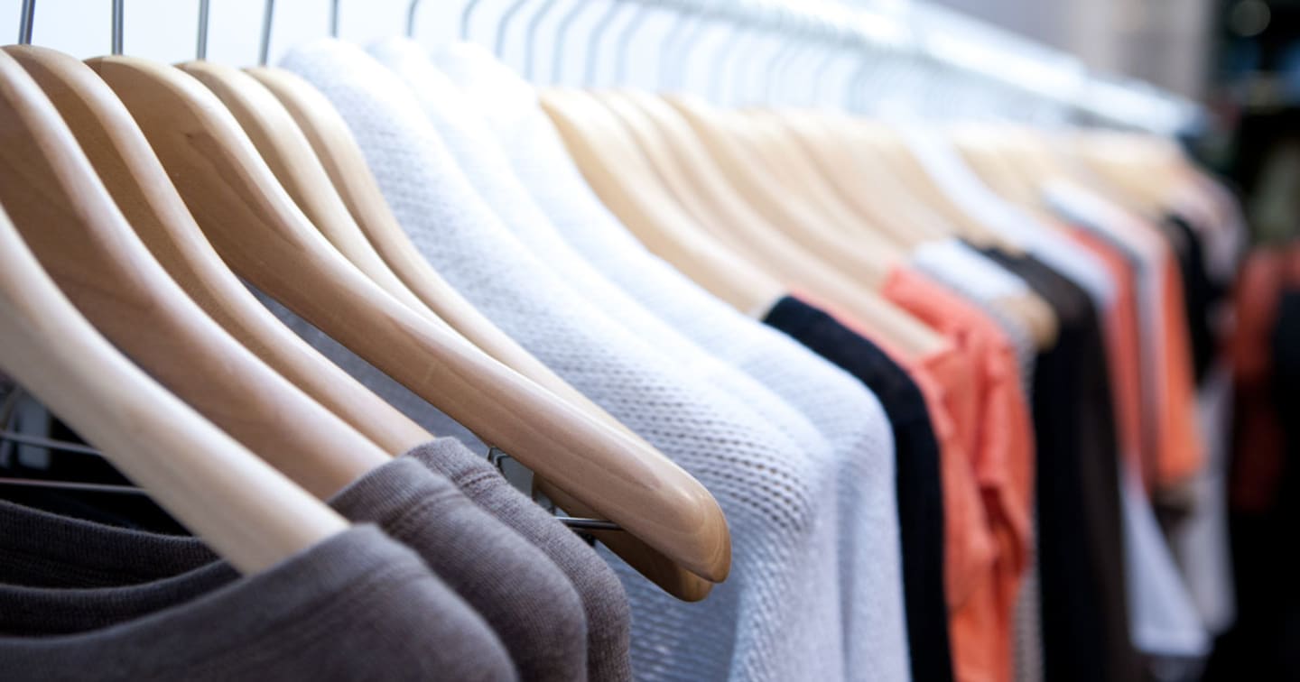 Clothing on hangers on a rack.