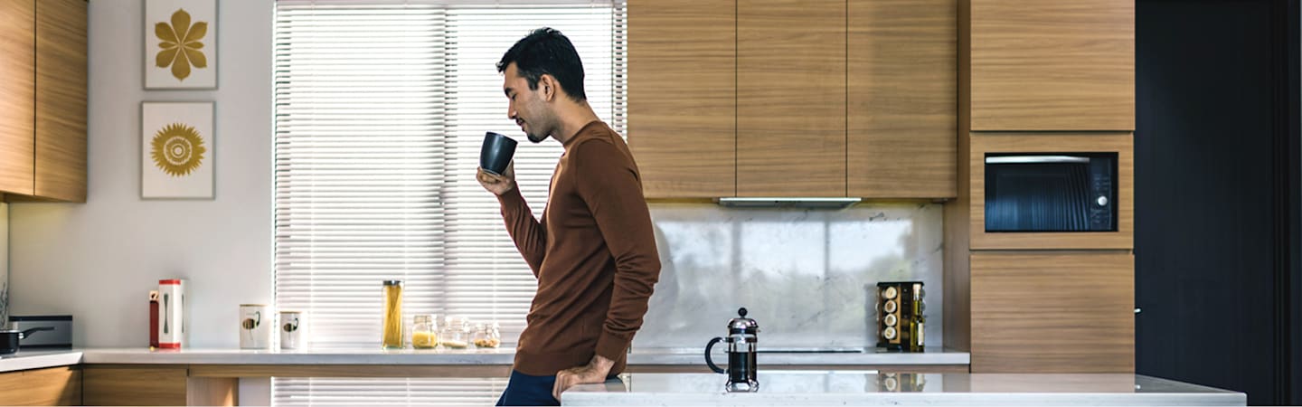 Man drinking coffee at home.