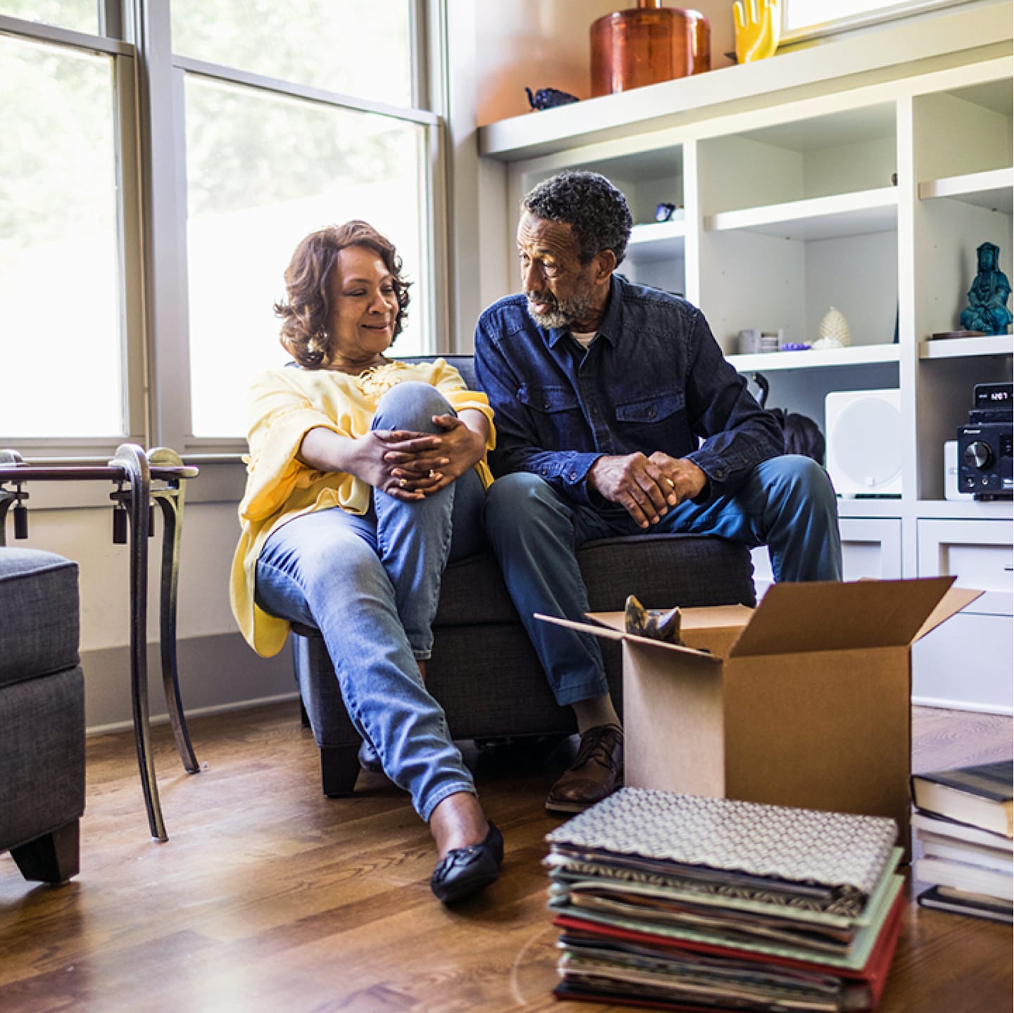 Retirement aged couple unpacking box.