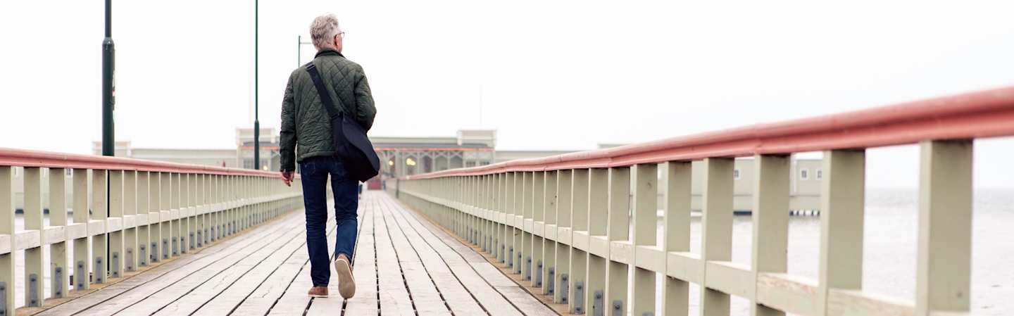 Man walking on pier.