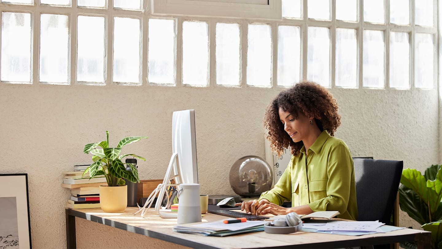 Woman working at computer in office.