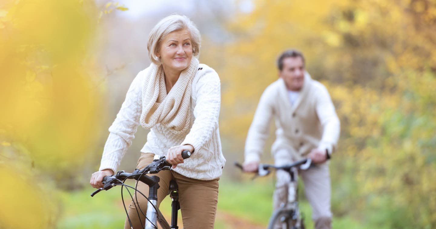 An older couple riding bikes.