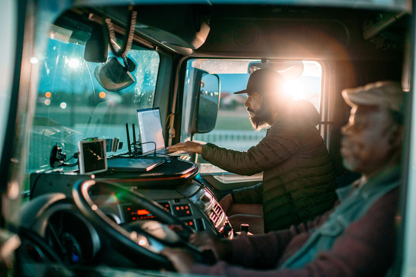 Two truckers check fuel data in their high-tech rig.