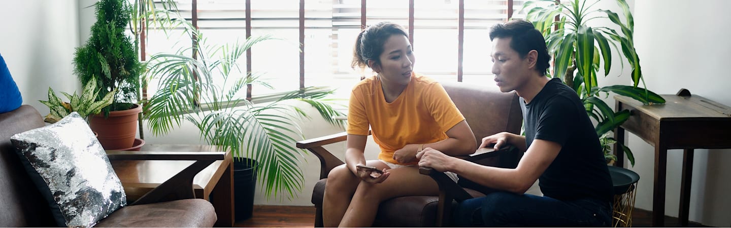 Couple talking in living room.