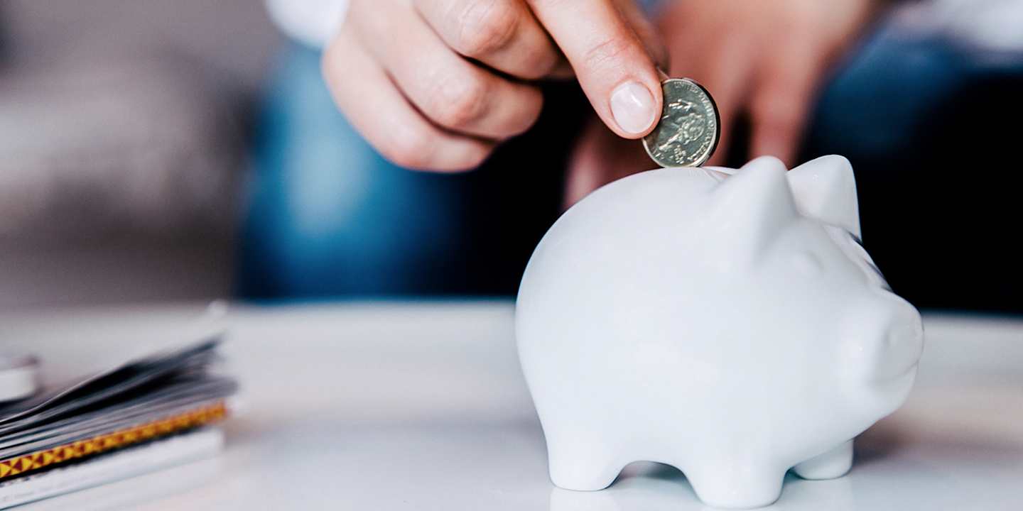 Putting money in a piggy bank.