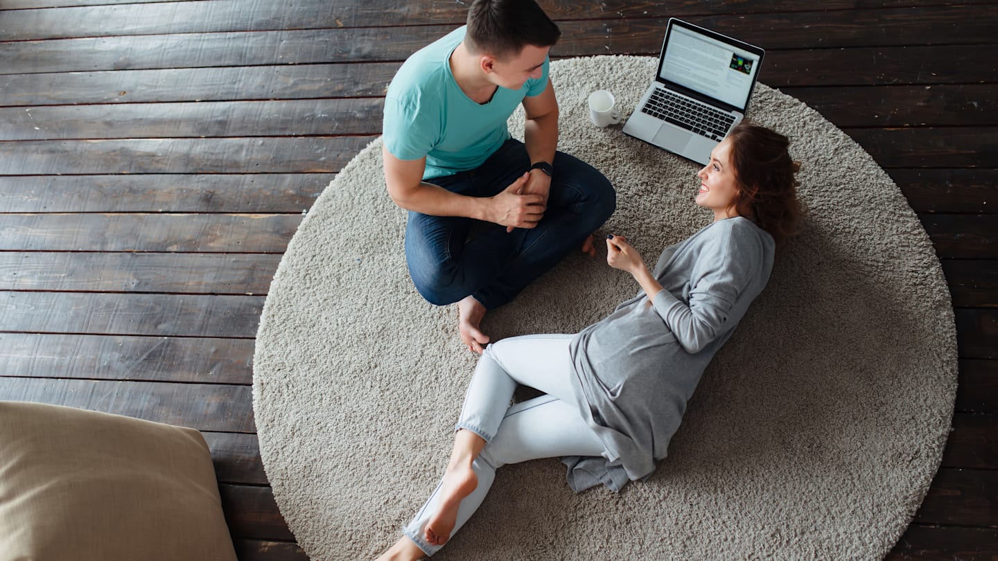 Couple having discussion on living room floor.