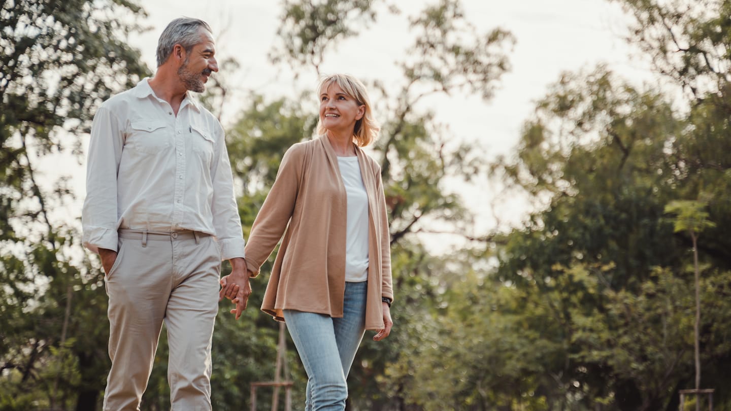 Retired couple going for a walk outside.