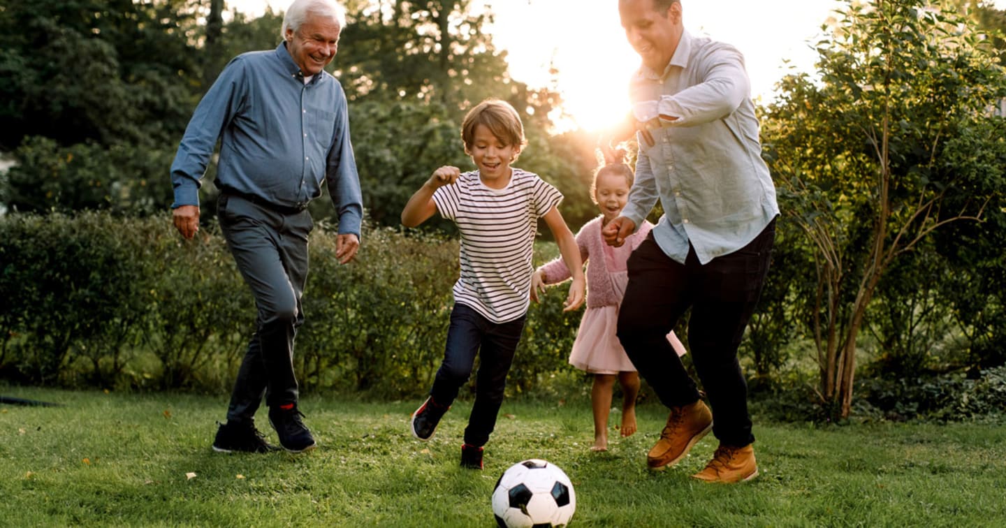 Grandparents playing soccer with grandchildren.