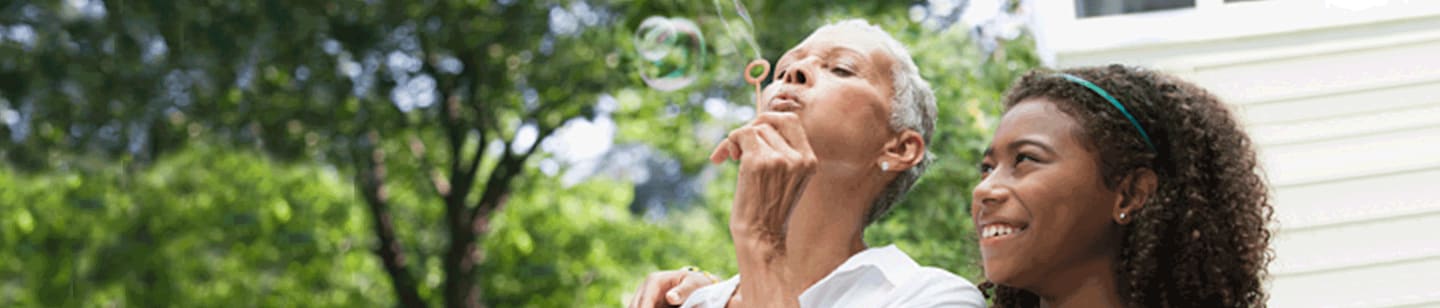 Older woman blowing bubbles.