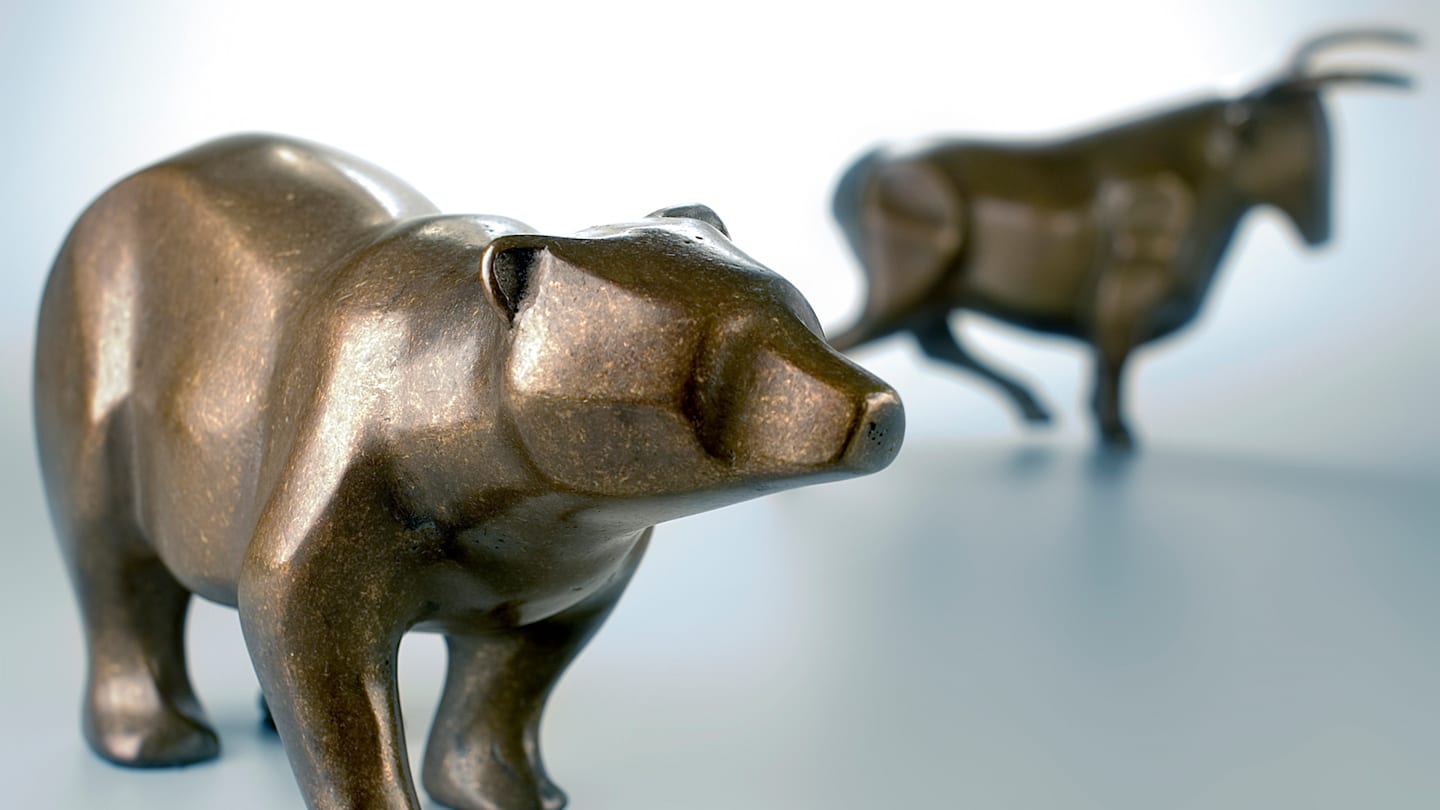 bronze bear in the foreground and bronze bull in the background