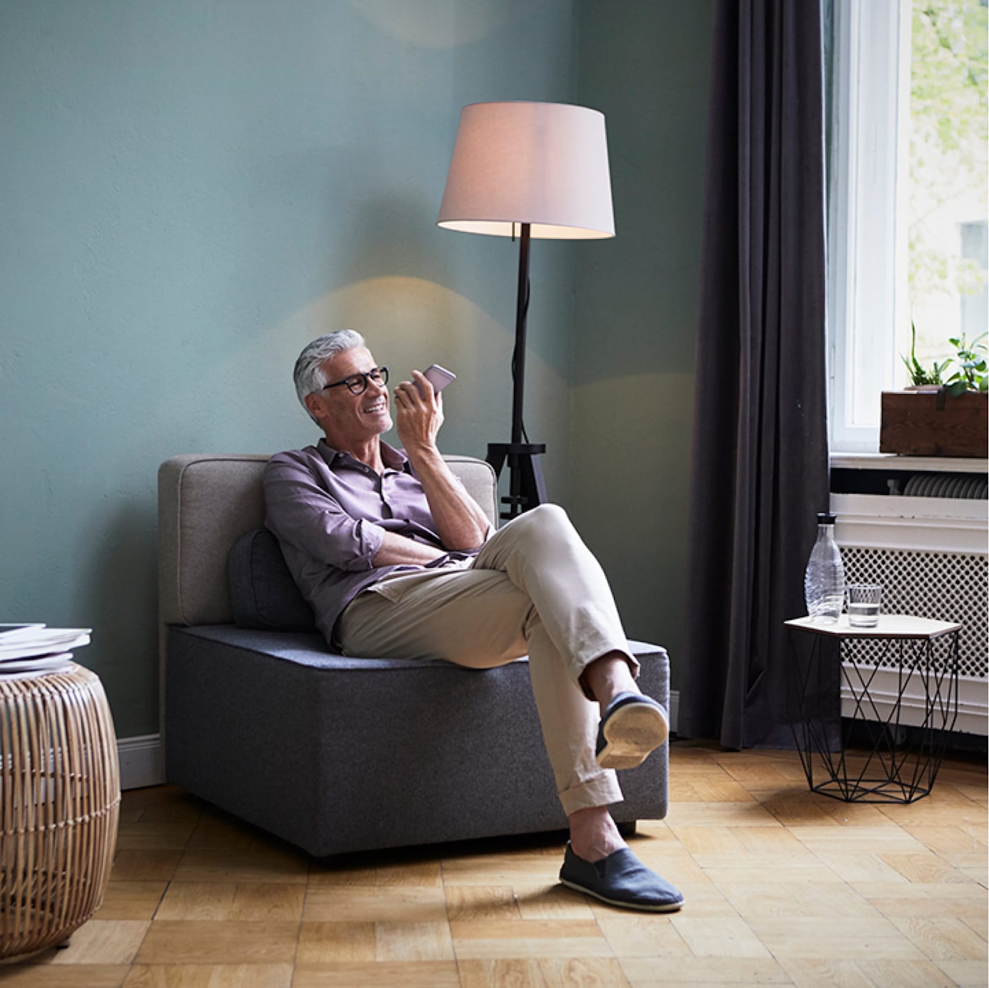 Man talking on phone in living room.