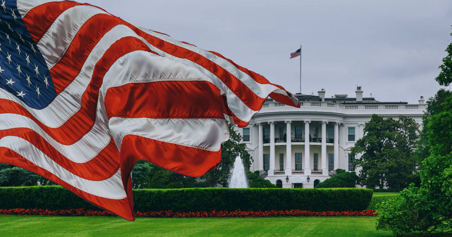 A picture of the White House with the American flag.