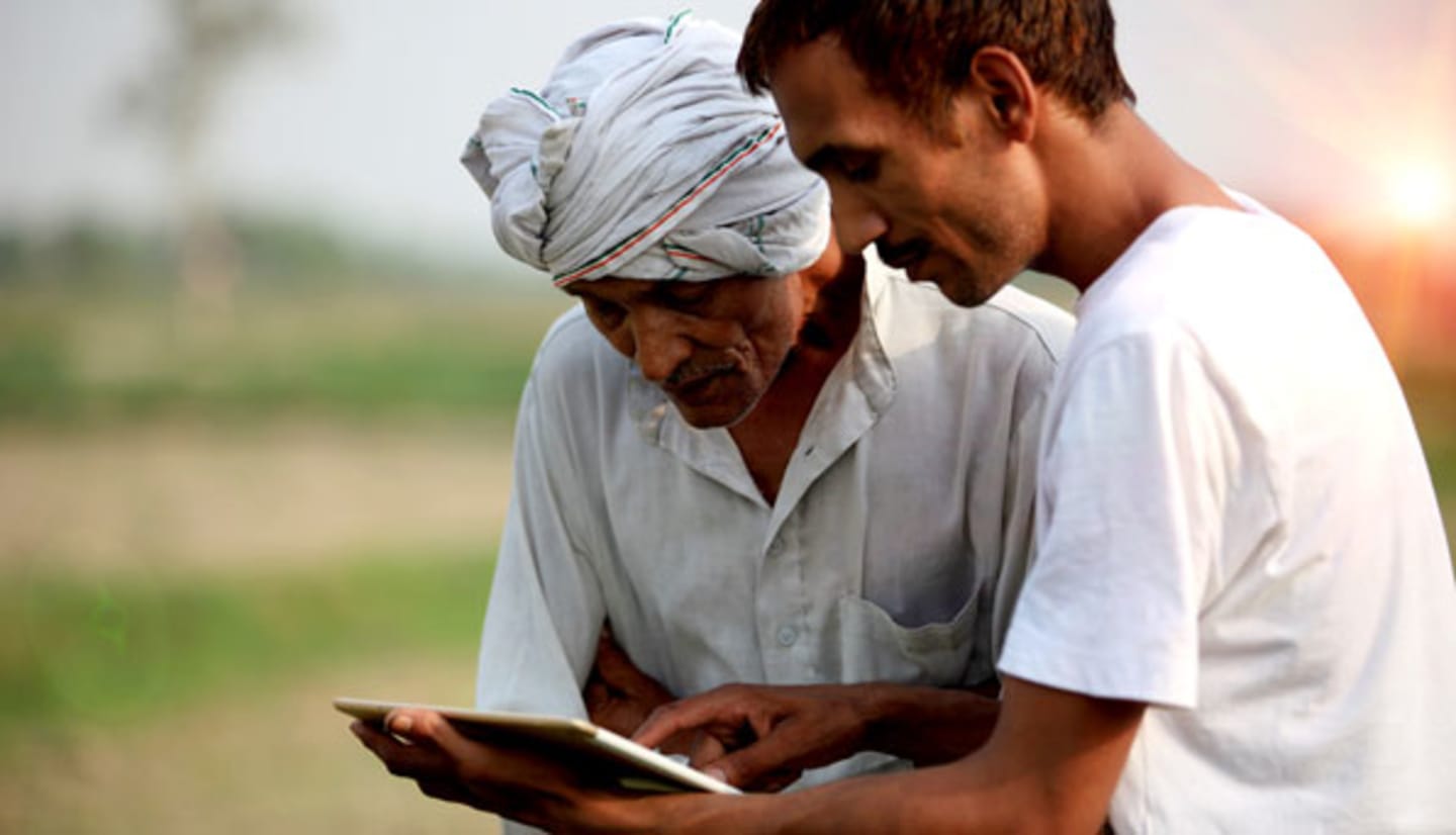 Two workers looking at tablet.