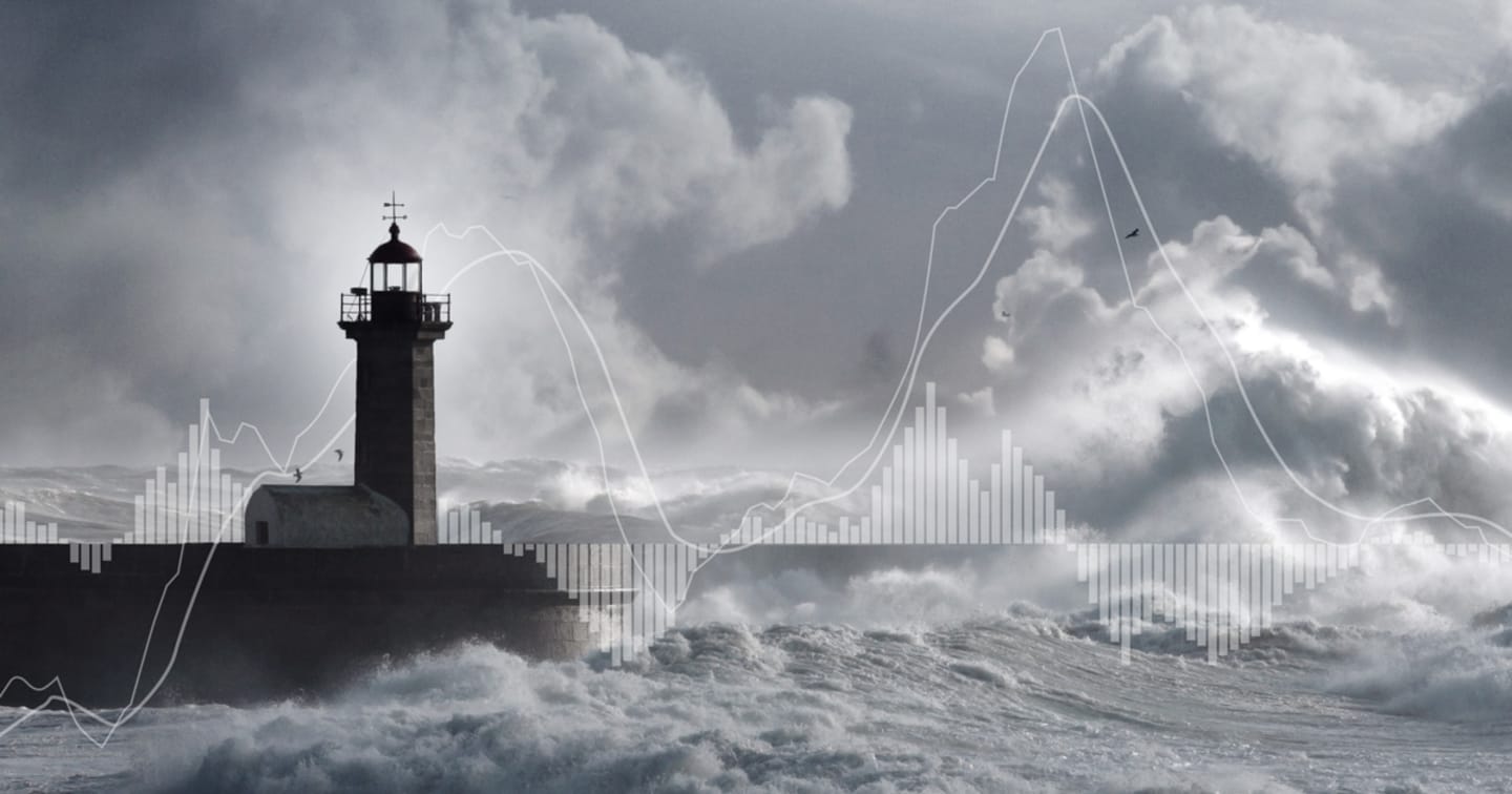 Lighthouse by ocean during a storm.