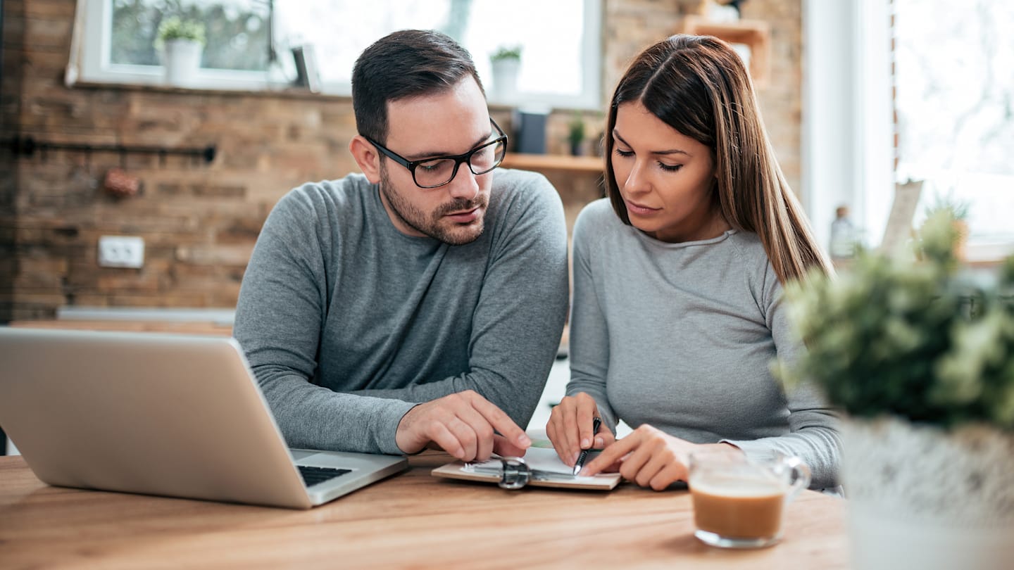 Couple reviewing paperwork at home.