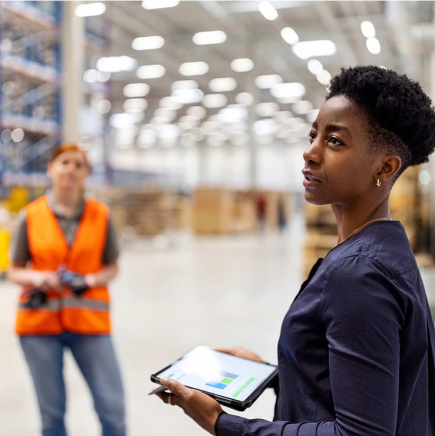 Woman with tablet in warehouse.