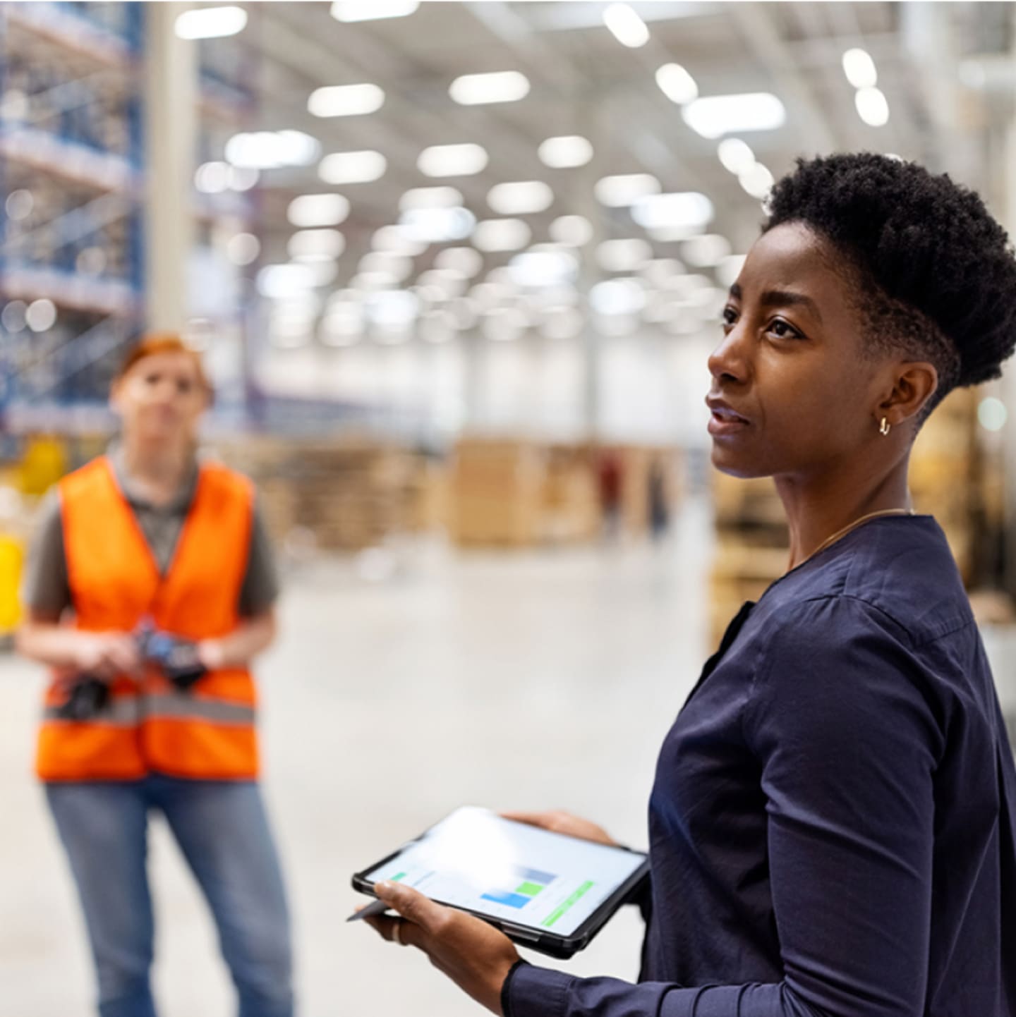 Woman with tablet in warehouse.