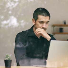 A man looking at his computer screen.