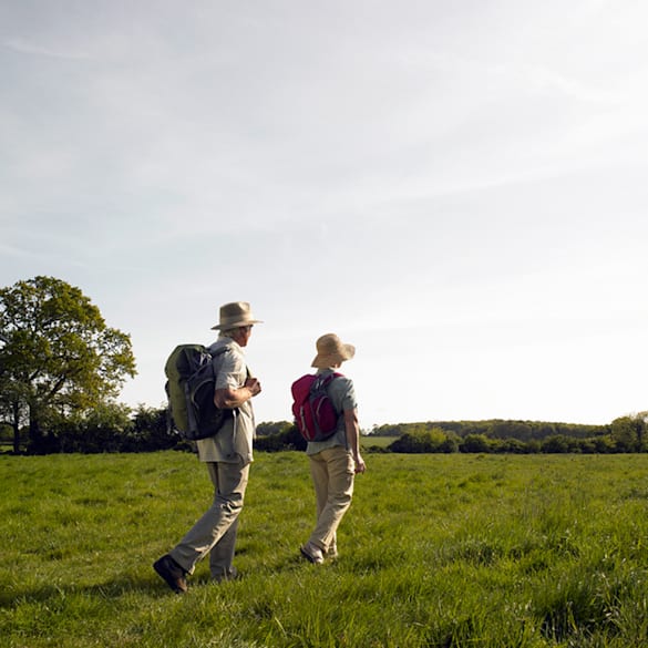 Older couple taking a long hike. 