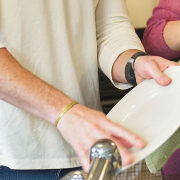 Image of a man and woman washing dishes in a modern kitchen