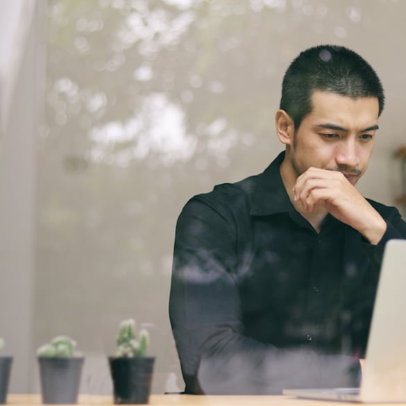 A man looking at his computer screen.