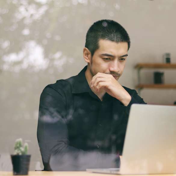 A man looking at his computer screen.