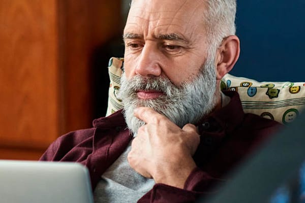 A man looking at his laptop.