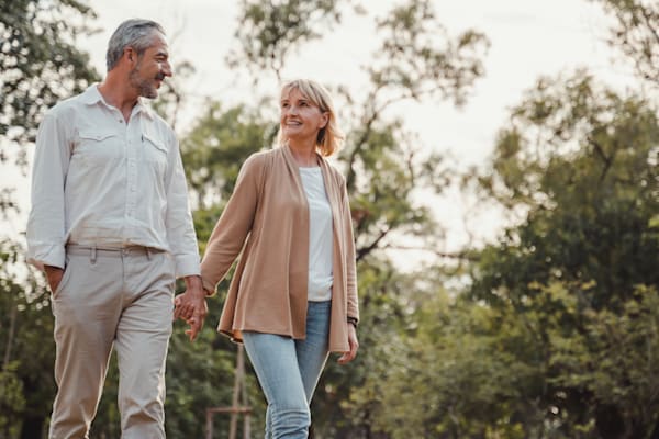 Retired couple going for a walk outside.