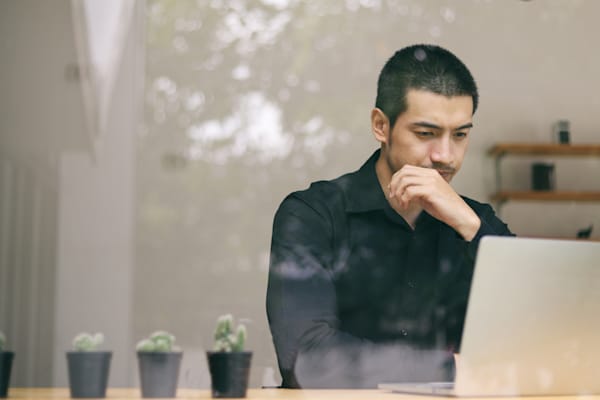 A man looks at his computer screen.